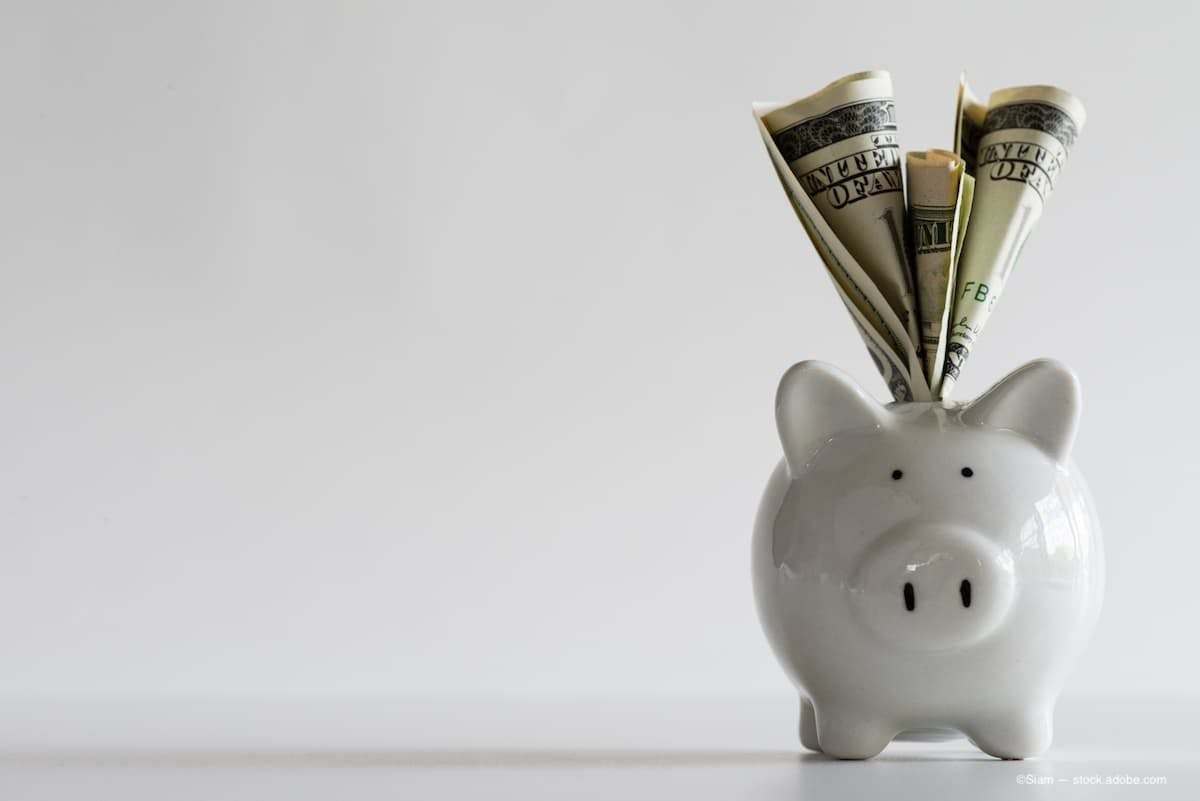 A piggy bank with money sticking out of the top slit. (Image credit: AdobeStock/Siam)