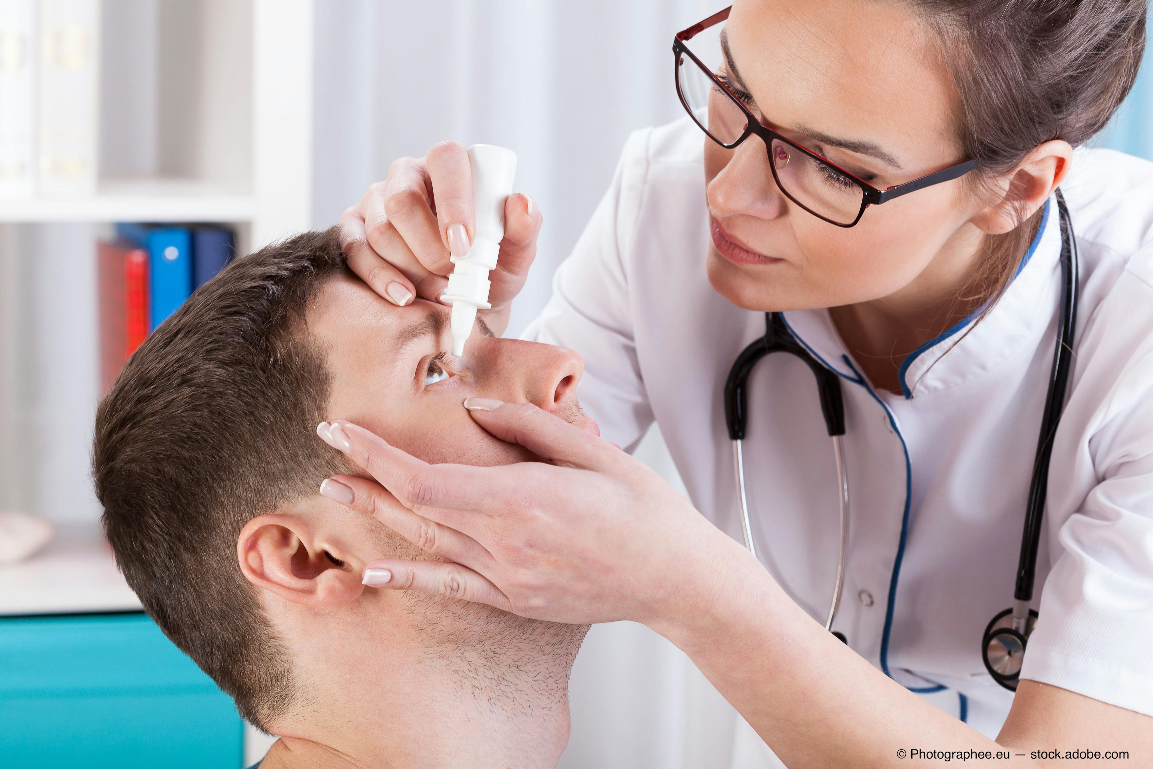 A female doctor putting eye drops into a male patient's eye