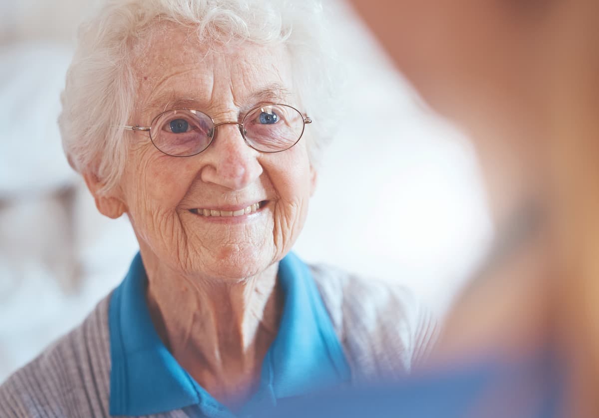 an older woman smiling and wearing glasses (Image Credit: AdobeStock)