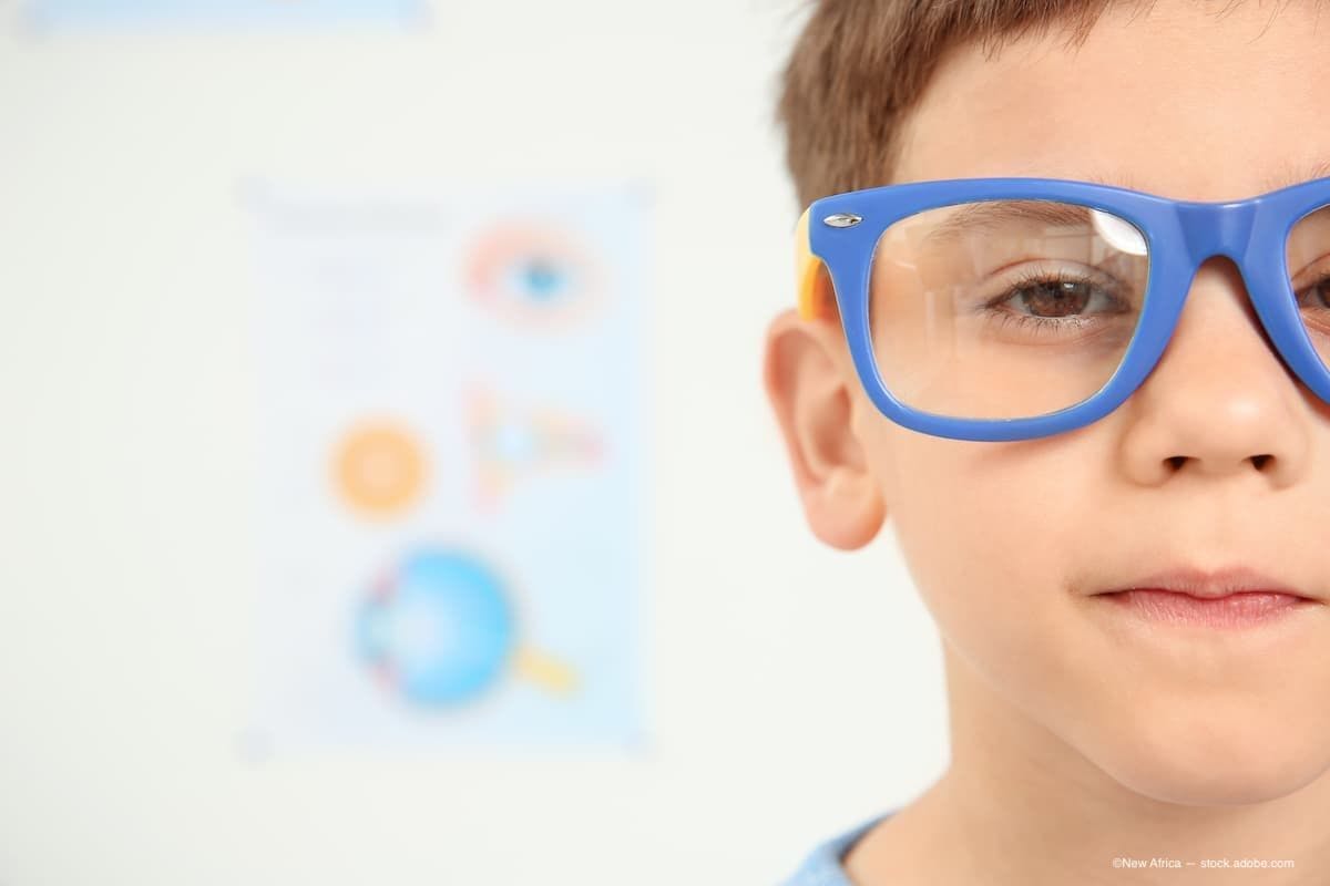 a boy wearing bright blue glasses at the eye doctor. (Image Credit: AdobeStock/New Africa)