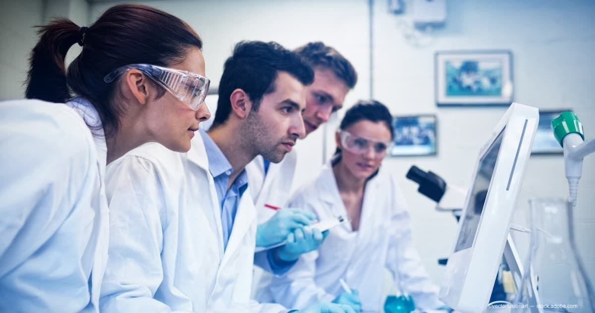 a team of researchers looking over date in a laboratory. (Image Credit: AdobeStock)