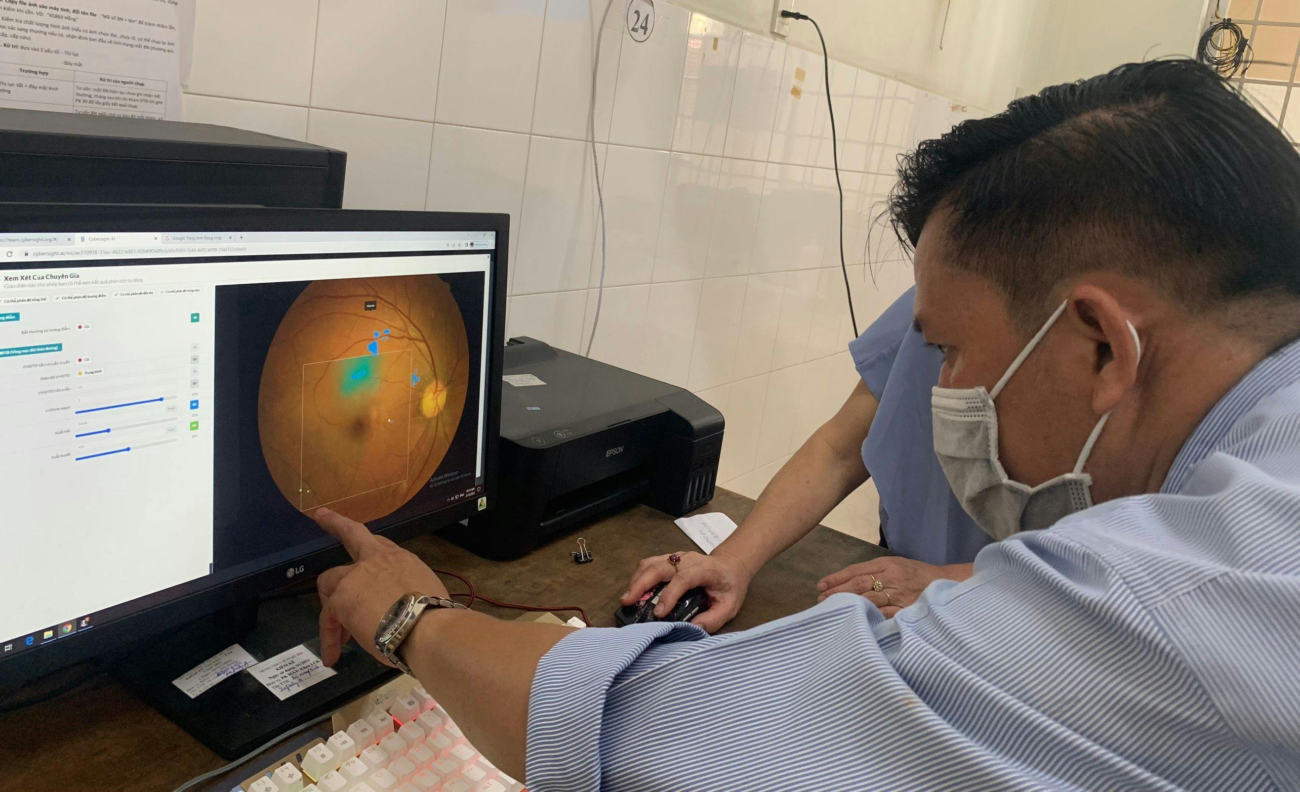 An ophthalmologist learns how to use Cybersight AI at My Tho Health Center.