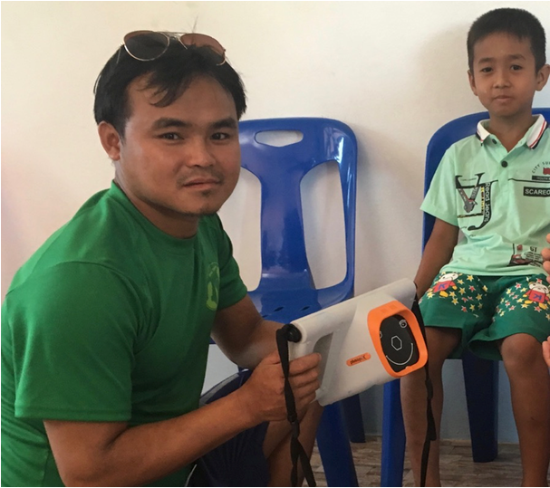 (FIGURE 2) Plusoptix photoscreener in a war zone in Burma. (Image courtesy of Dr. Arnold) 