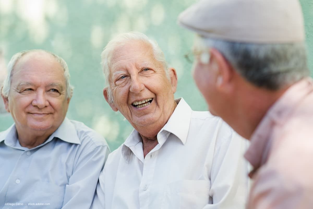 Three old men sitting and laughing. (Image Credit: AdobeStock/Diego Cervo)