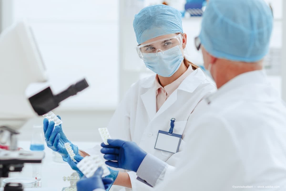 doctors discussing a new drug in a lab. (Image Credit: AdobeStock/yurolaitsalbert)