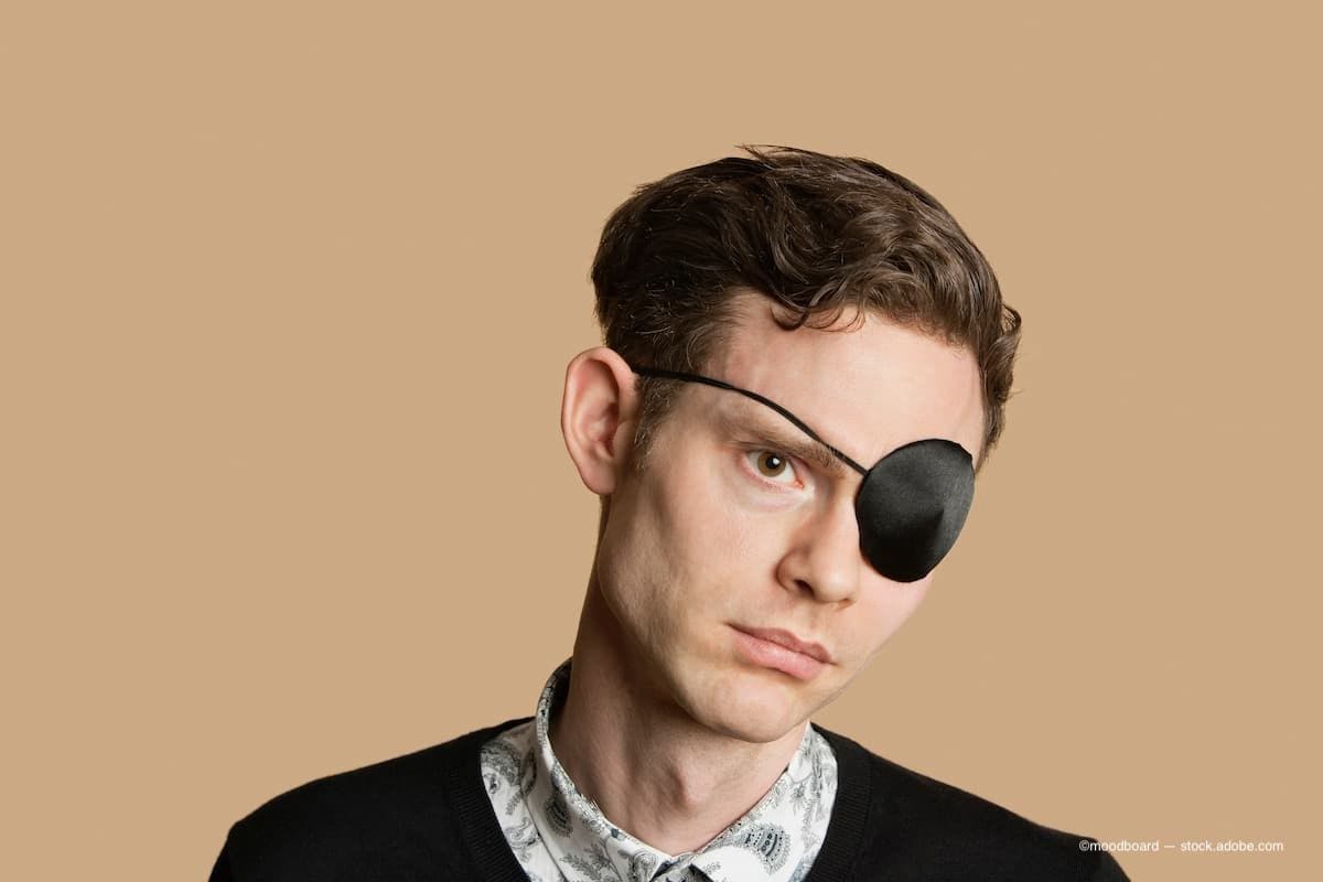 A sad man wearing an eye patch. (Image Credit: AdobeStock/moodboard)