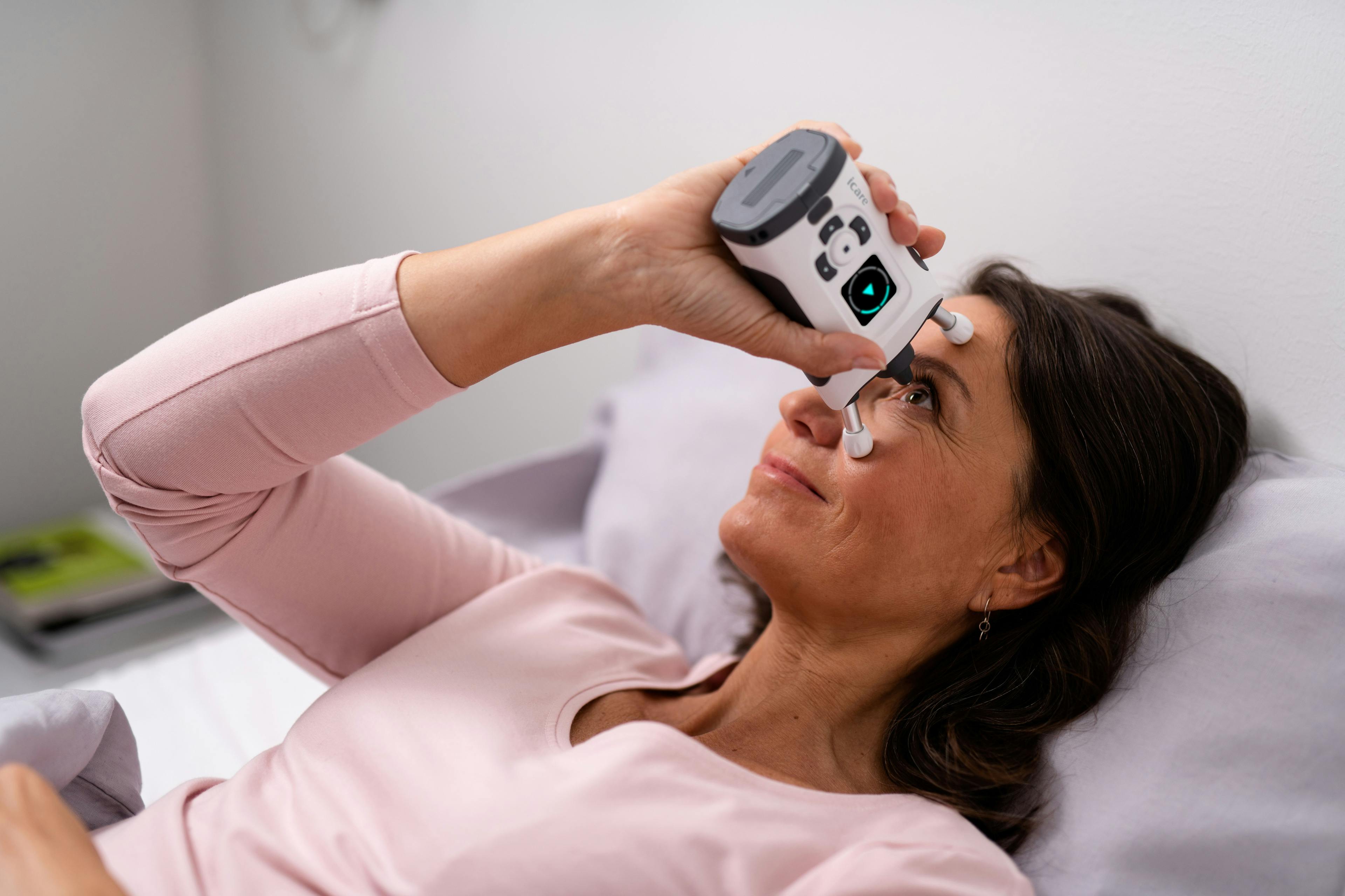 A patient measures her IOP with the iCare HOME2 tonometer