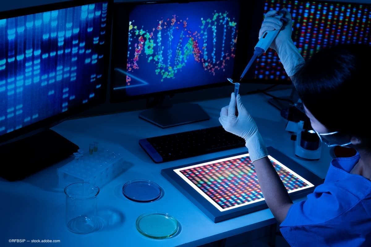 A doctor in a lab looking over gene therapy results in front of a computer. (Image Credit: AdobeStock/RFBSIP)