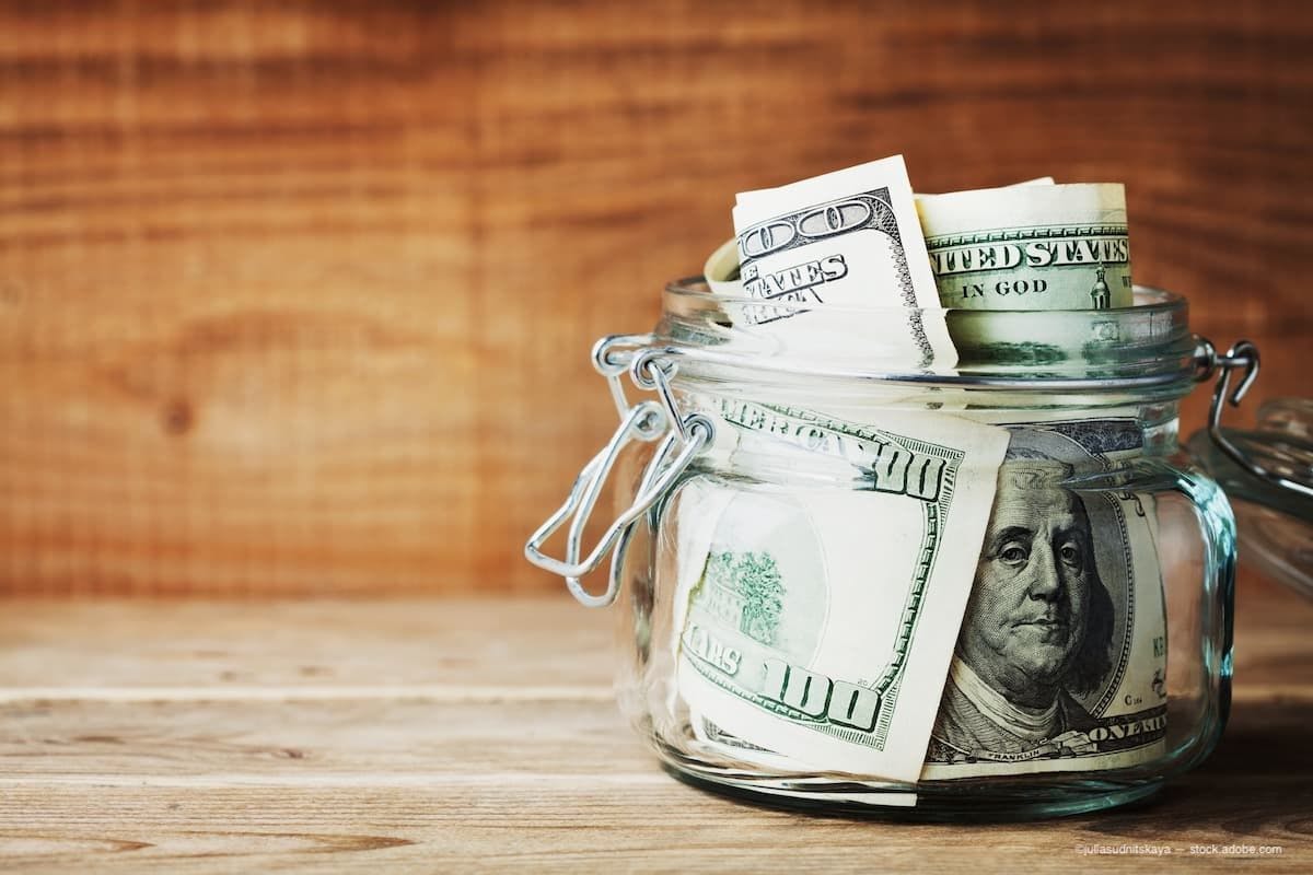 Money in a jar. (Image Credit: AdobeStock/juliasudnitskaya)