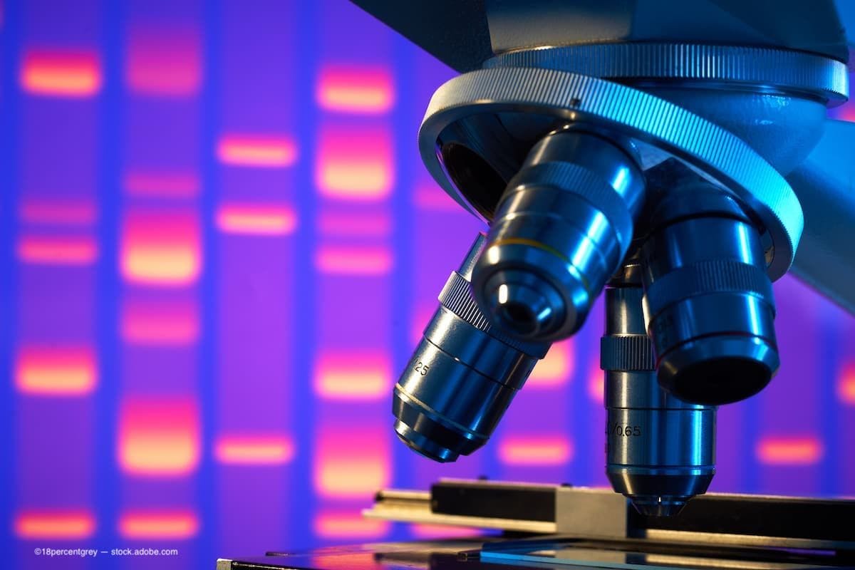 a close image of a microscope in a laboratory with a purple background. (Image Credit: AdobeStock/18percentgrey)