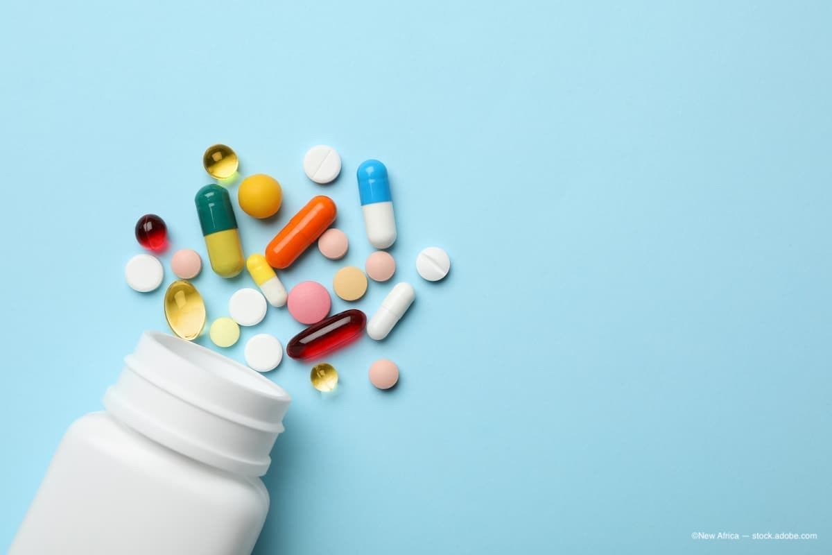 an image of a bottle of vitamins spilled out with pills coming out of it. (Image Credit: AdobeStock/New Africa)