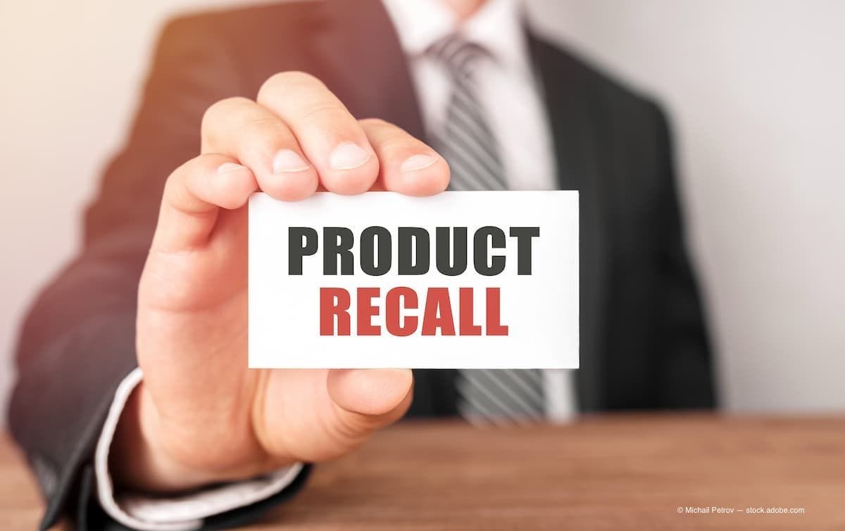 a man holding a cad with the text "product recall" on it