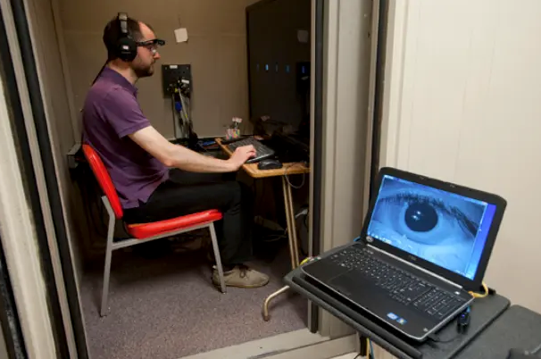 Research engineer Sylvain Favrot wears the portable eye-tracker component of the visually guided hearing aid (VGHA) developed by Gerald Kidd, PhD, and other researchers. (Image by Cydney Scott, courtesy of Boston University)
