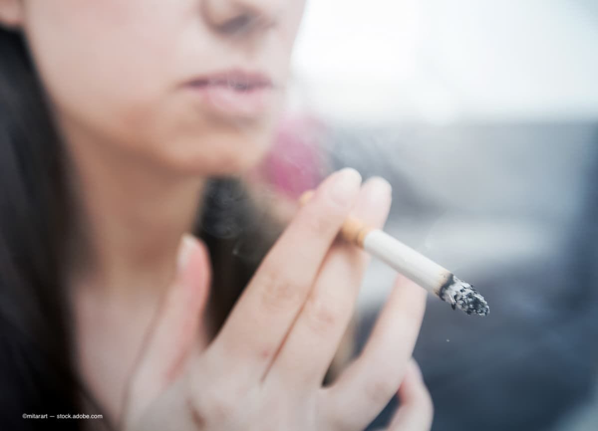 an image of a female smoking a cigarette. (Image Credit: AdobeStock/mitarart)