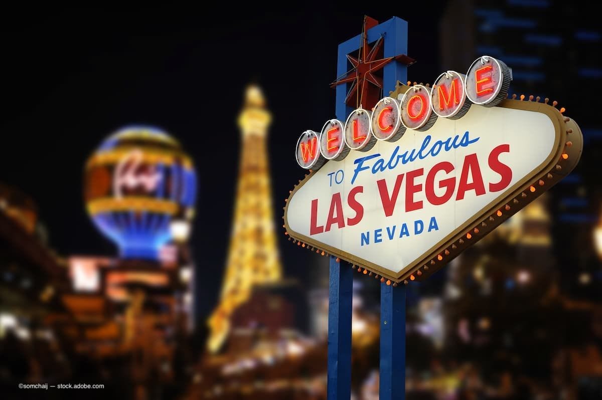 a photo of the welcome to las vegas sign with the skyline in the background. (Image Credit: AdobeStock/somchaij)