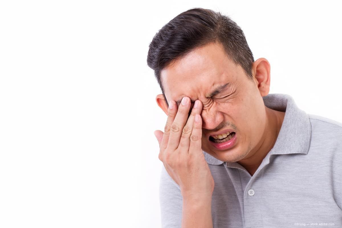 A man experiencing eye pain. (Image Credit: AdobeStock/9nong)