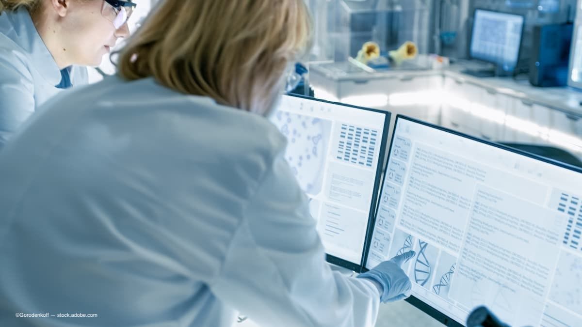 a doctor looking over scientific data on the computer. (Image Credit: AdobeStock/Gorodenkoff)
