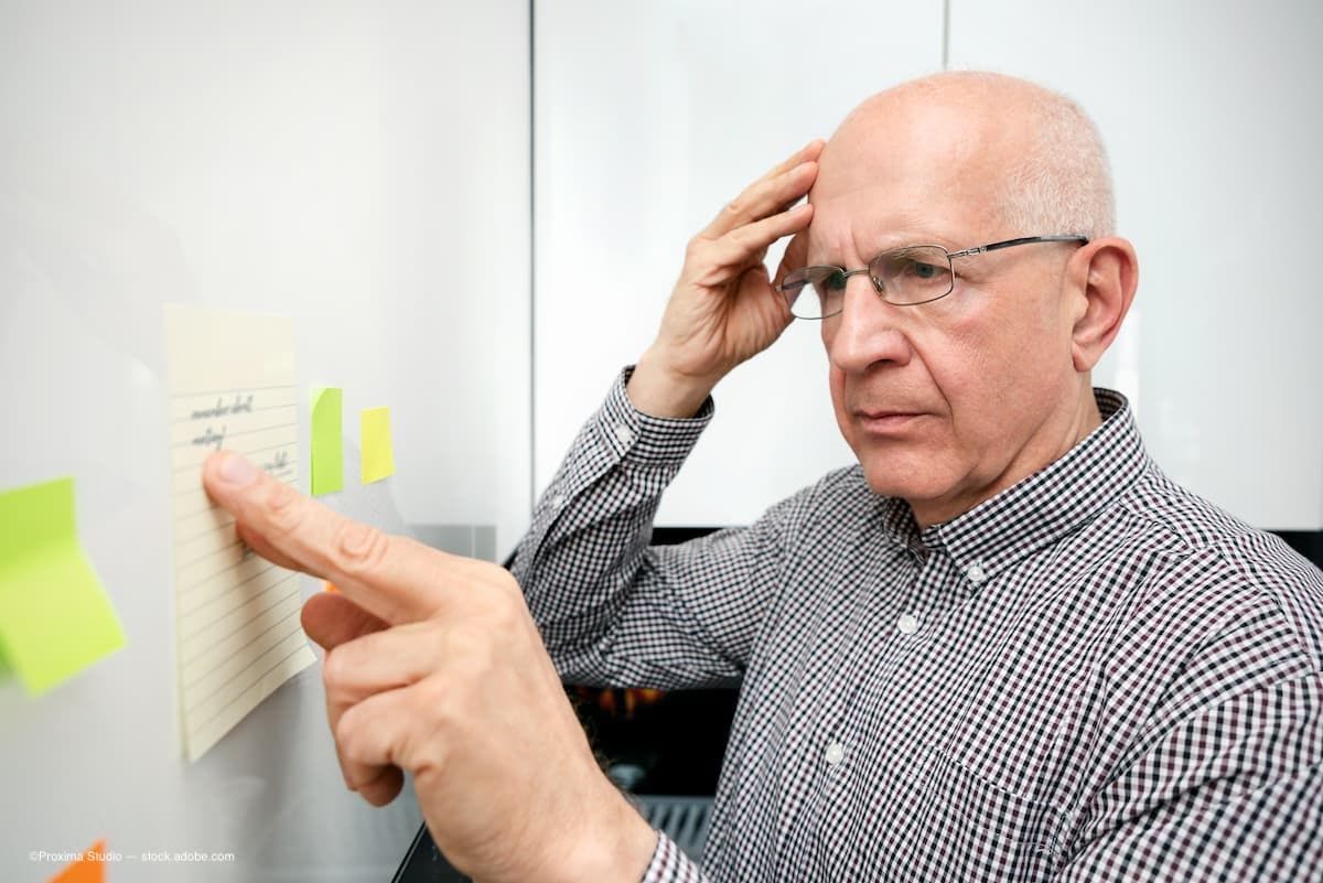 a man with dementia looking at notes on the wall. (Image Credit: AdobeStock/Proxima Studio)