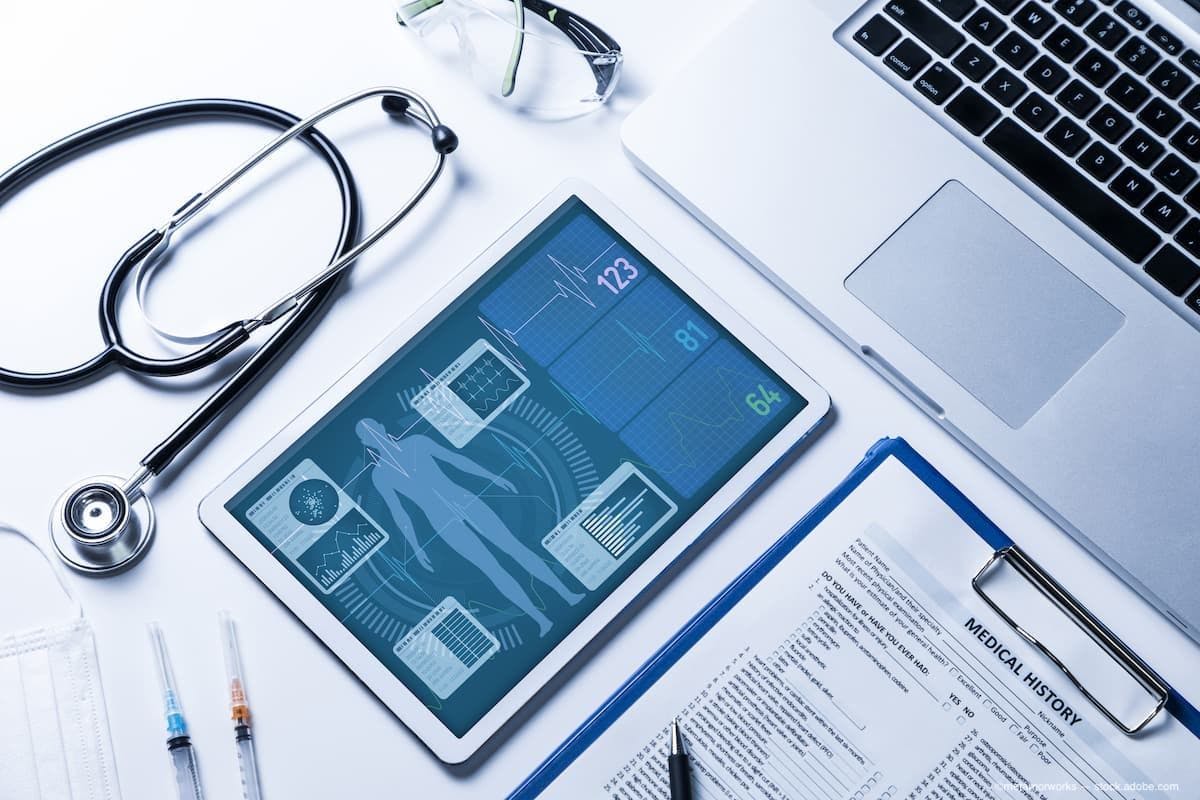 a patients medical history on the table with a chart and a laptop. (Image Credit: AdobeStock/metamorworks)