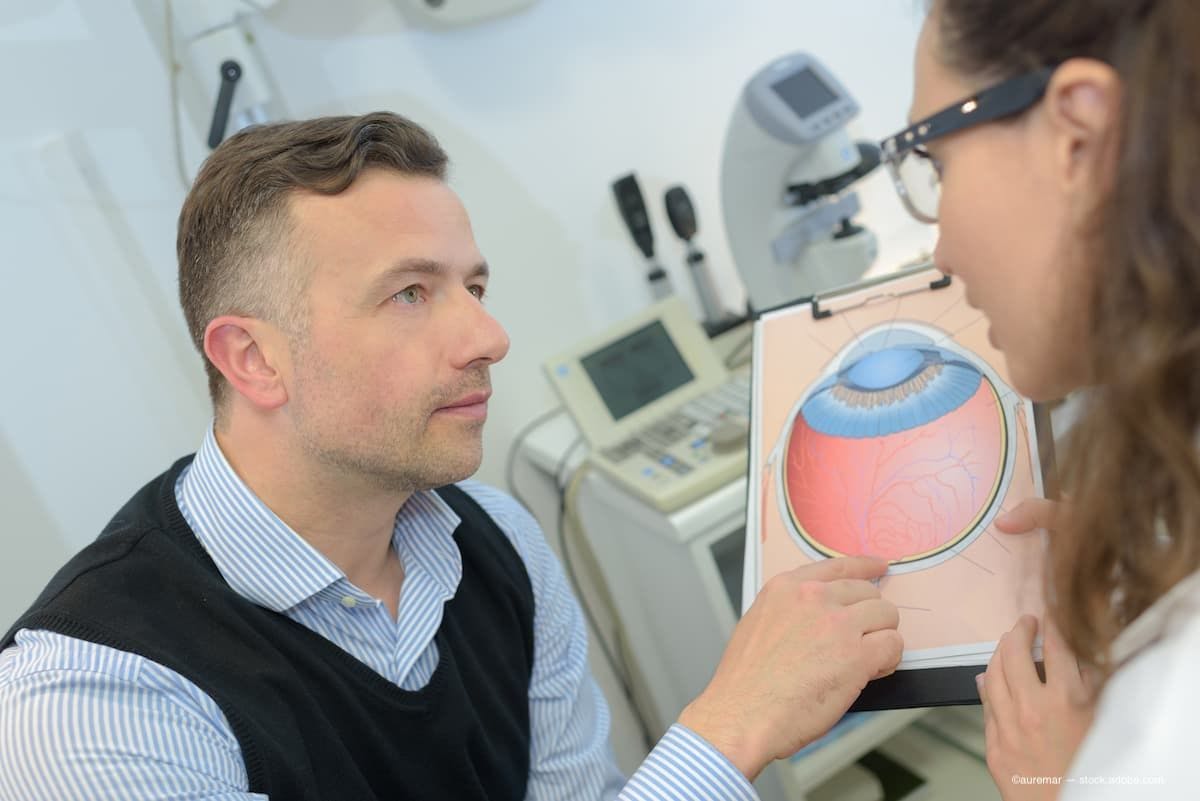 a doctor and a patient sitting and looking at a diagram of the eye. (Image Credit: AdobeStock/auremar)