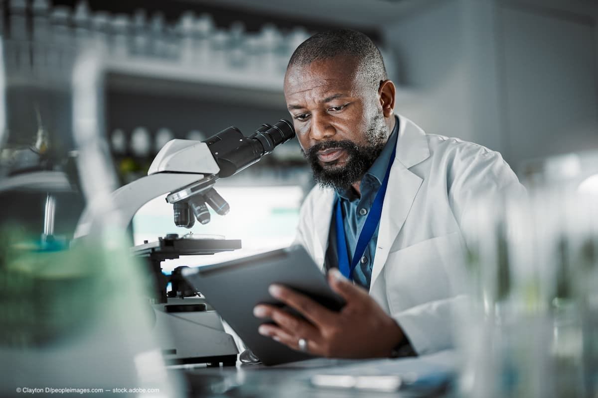 An older black doctor sitting in a lab looking at research information. (Image Credit: AdobeStock/Clayton D/peopleimages.com)