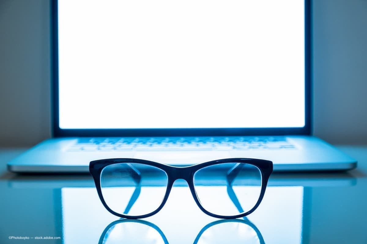 Glasses sitting on a laptop with the screen on very bright (Image Credit: AdobeStock/Photoboyko)